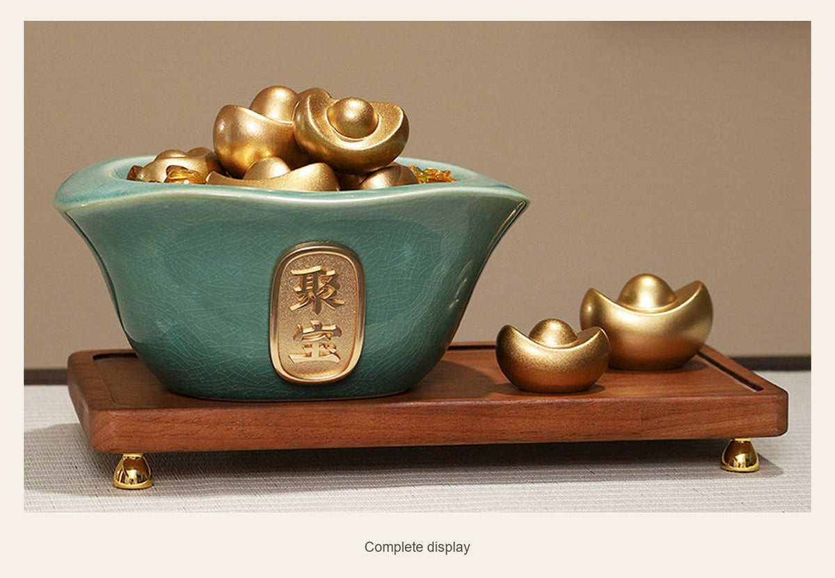 Green glazed ceramic wealth bowl with alloy ingots on its wood display base