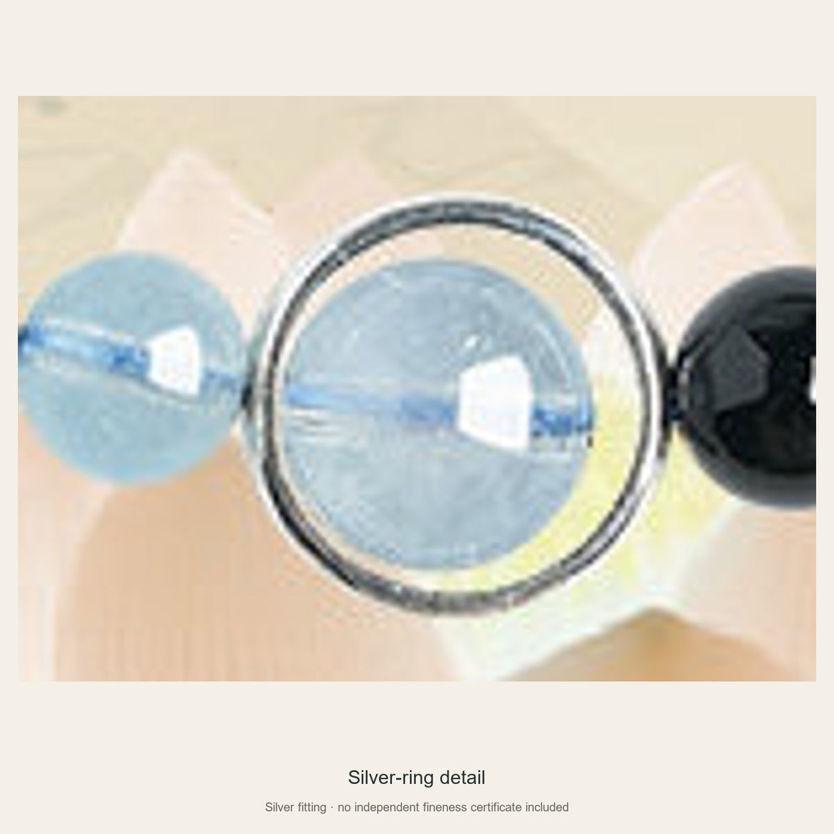 Close view of aquamarine focal bead enclosed by silver fitting