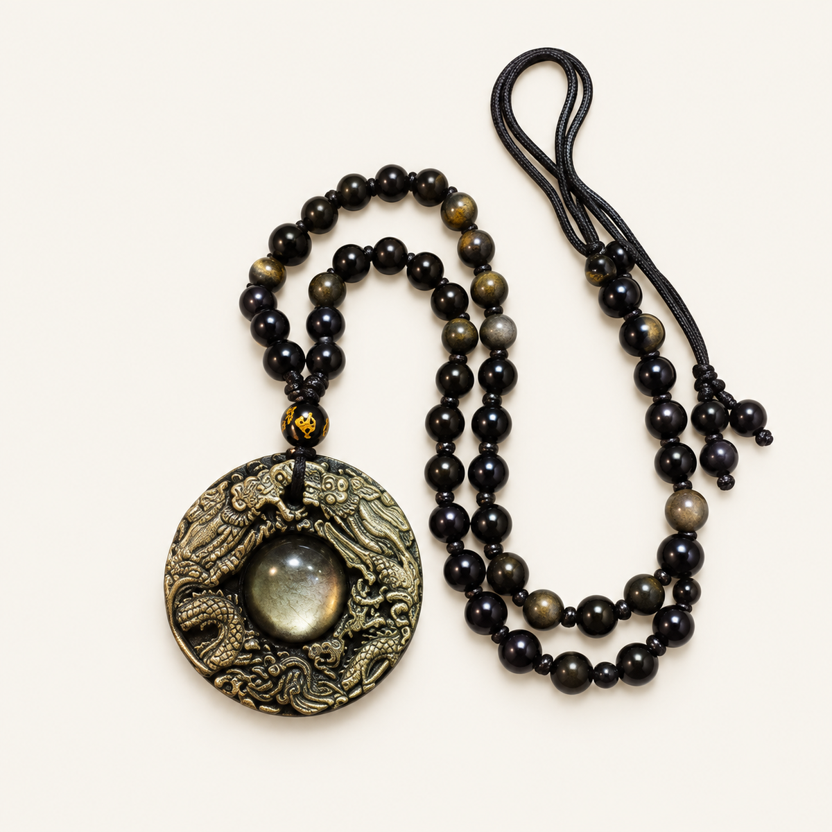 Black Obsidian Twin Dragon Pendant on an ivory background