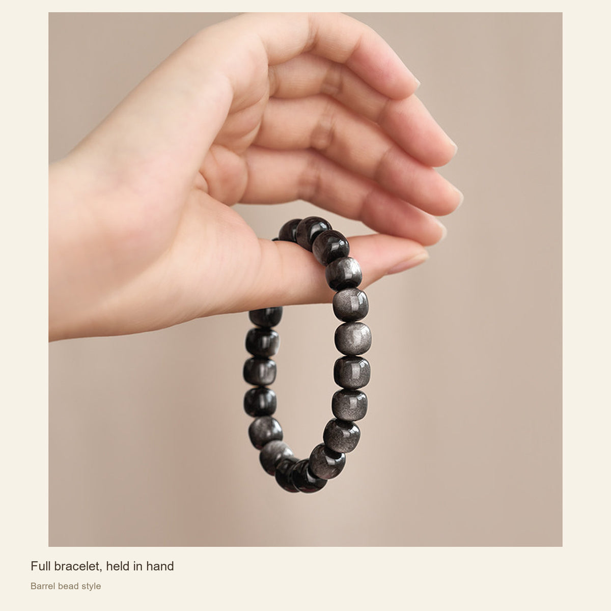 Silver Sheen Obsidian Bracelet — Round & Barrel Beads — Full bracelet, held in hand; Barrel bead style #Style_Barrel beads