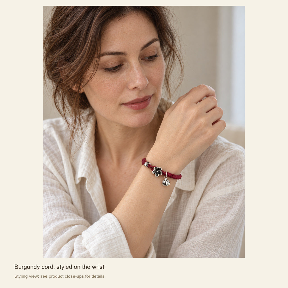 Burgundy Red Cord Bracelet with Sterling Silver Floral Clasp — Burgundy cord, styled on the wrist; Styling view; see product close-ups for details