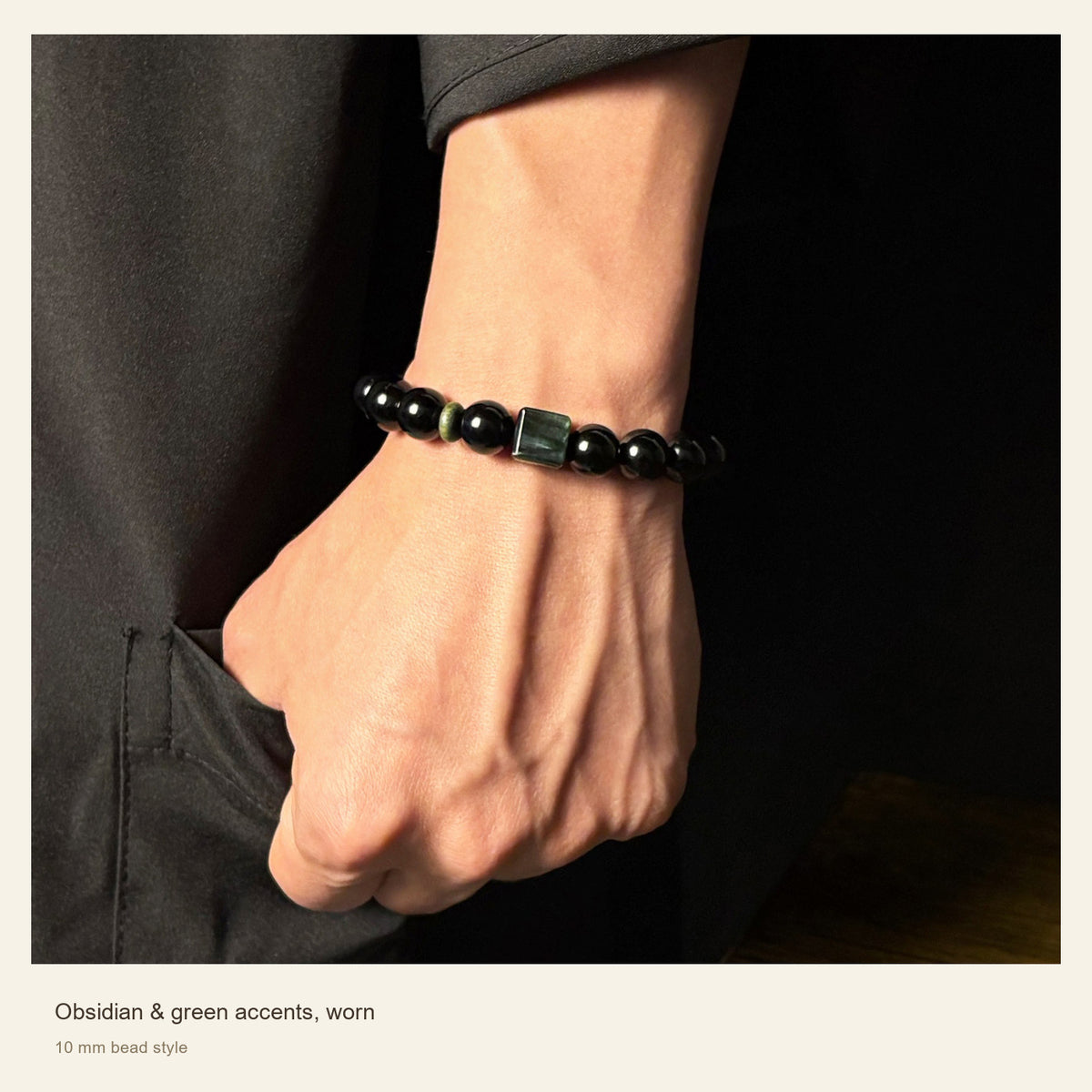 Obsidian, Green Stone & Wood Bead Bracelet β Obsidian & green accents, worn; 10 mm bead style