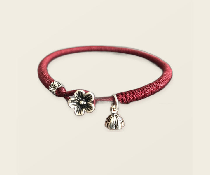 Burgundy red cord bracelet with silver floral charms
