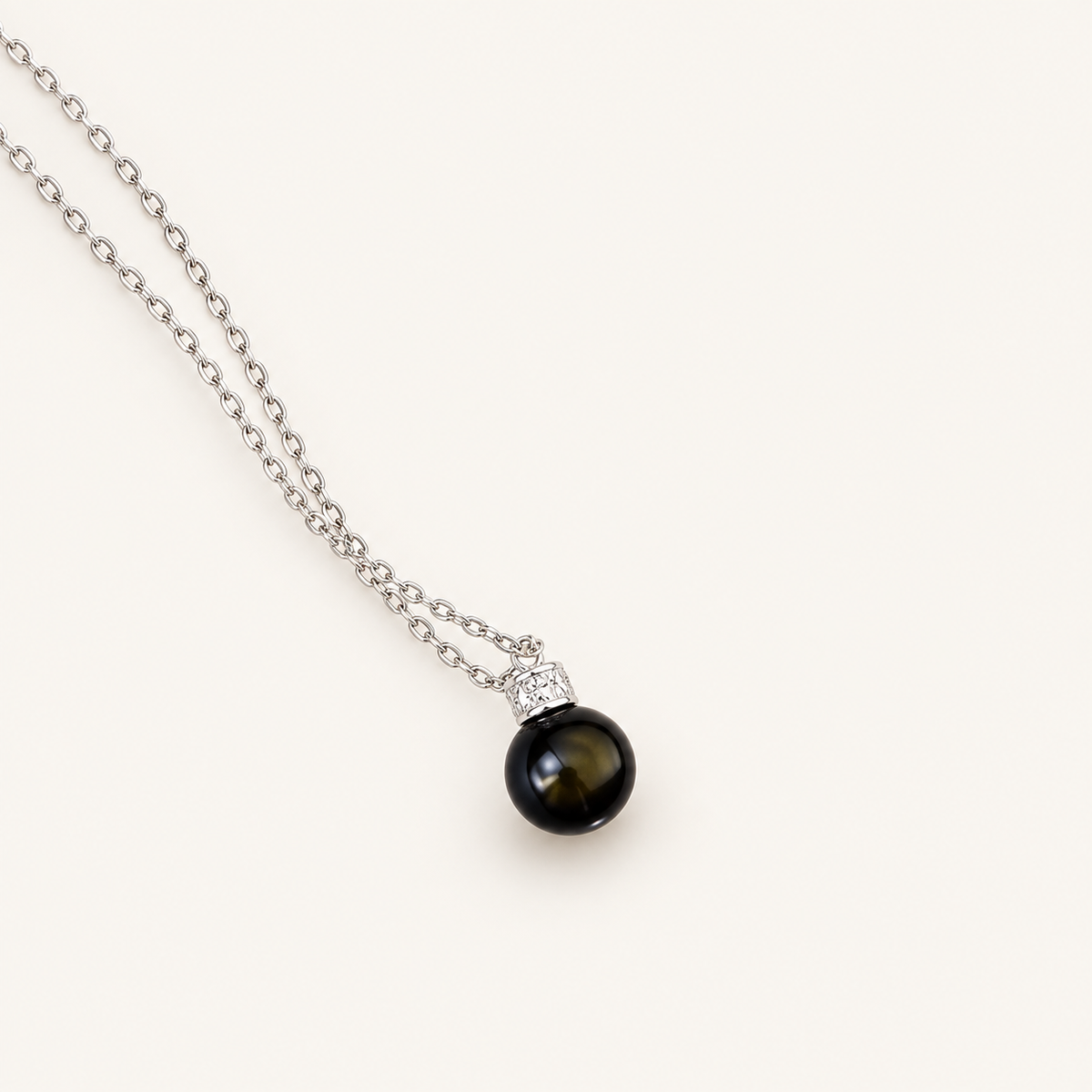 Obsidian & S925 Silver Protection Necklace on an ivory background