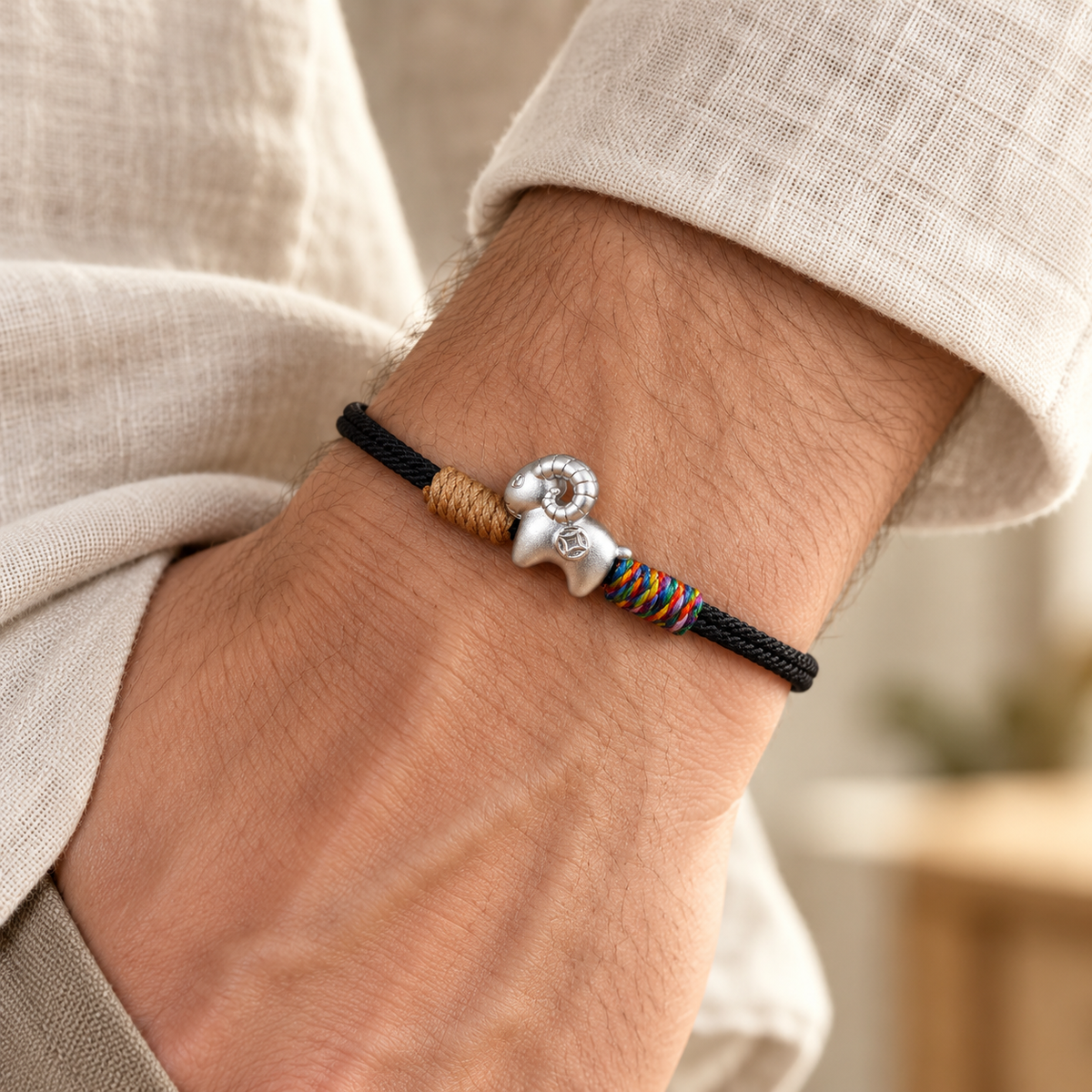 Black fine silver goat bracelet worn on an adult wrist #cord color_black