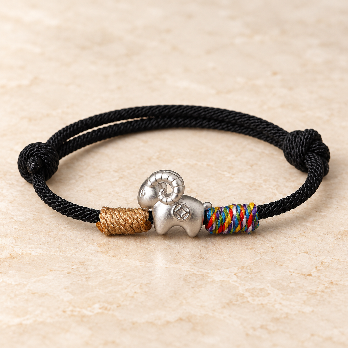 Fine silver goat charm on a black cord with tan and multicolored woven accents #cord color_black