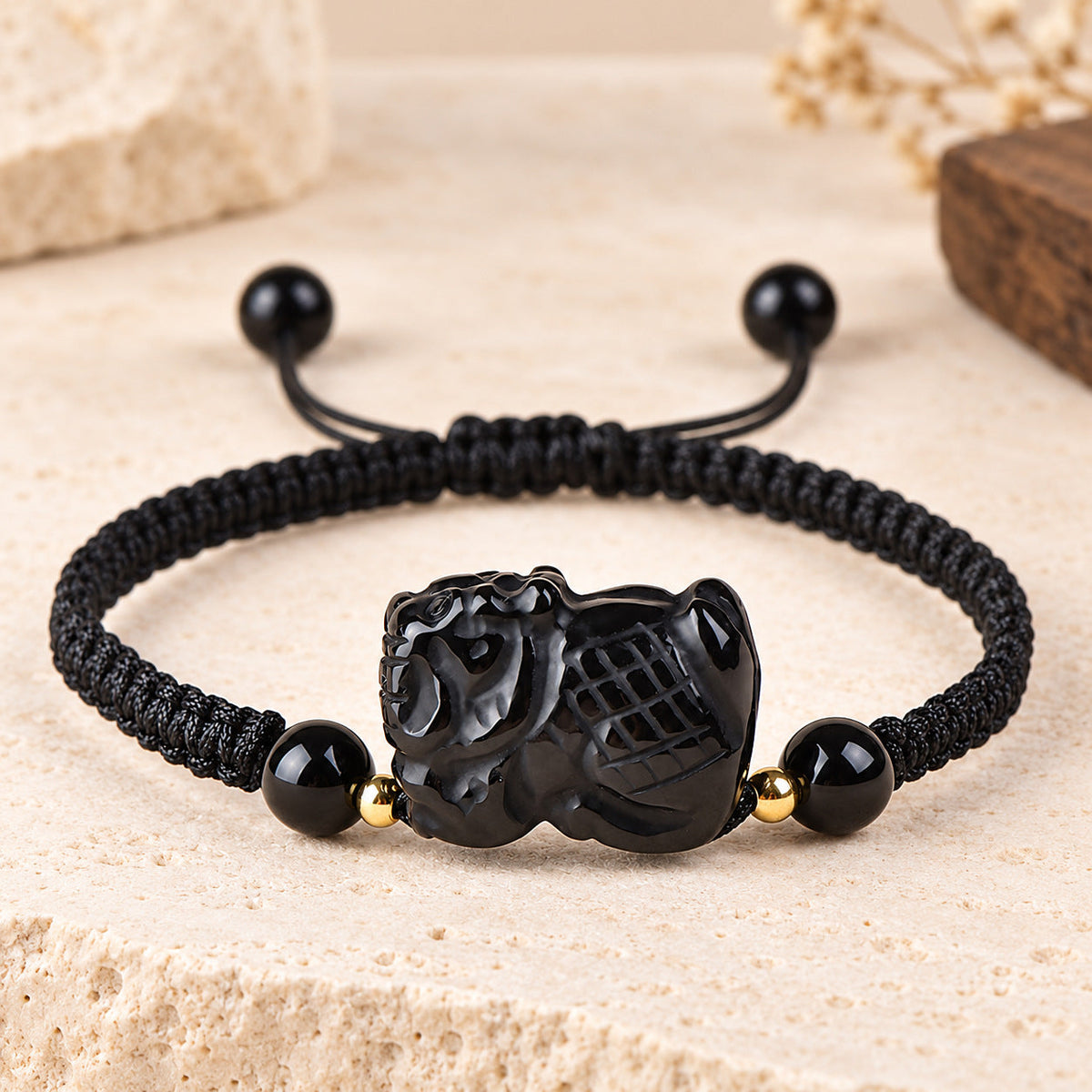 Black obsidian Dragon zodiac carving on a braided cord bracelet