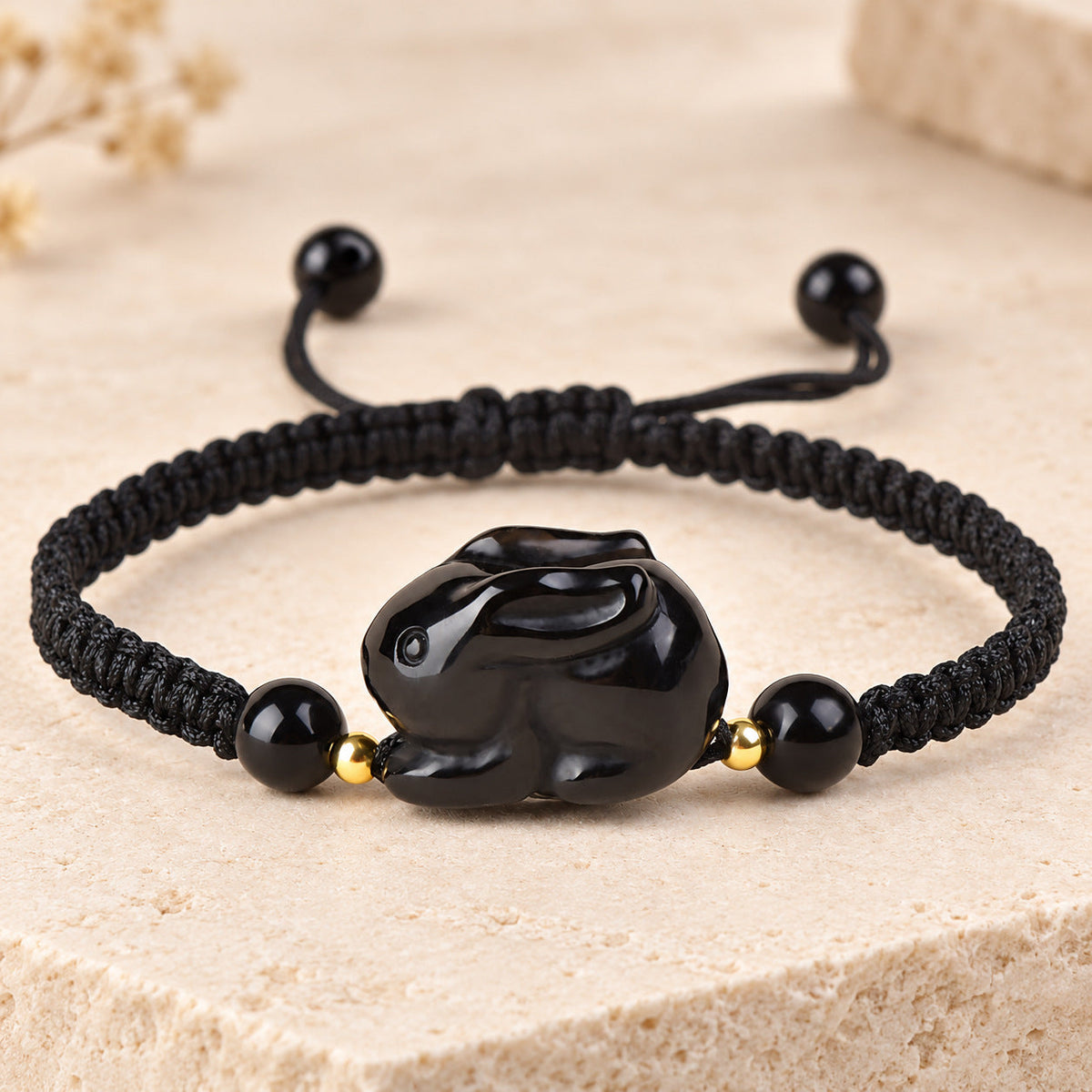 Black obsidian Rabbit zodiac carving on a braided cord bracelet