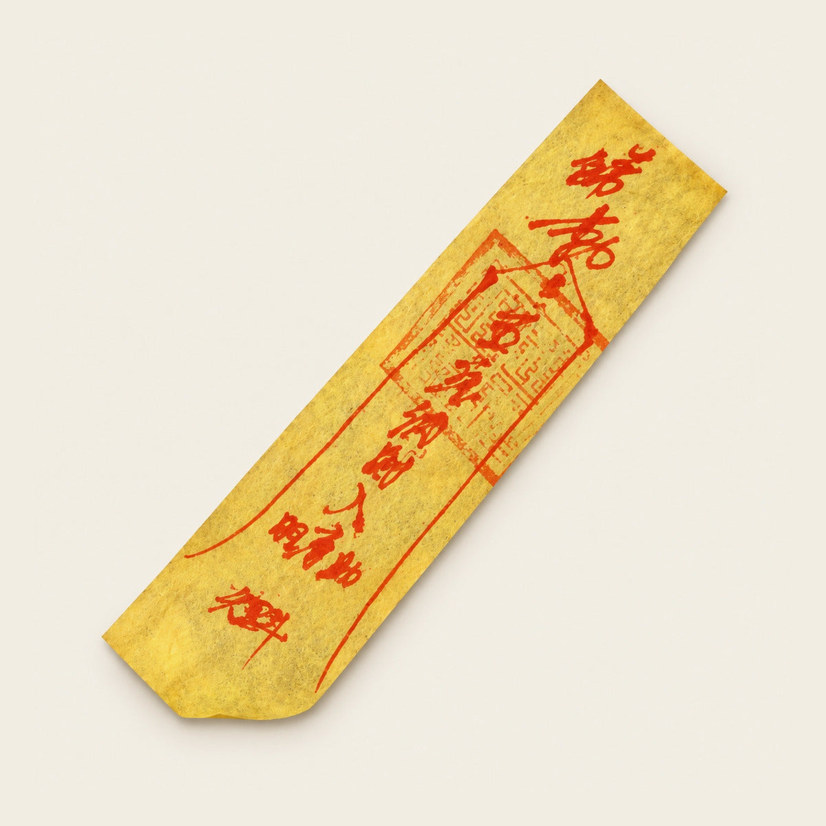 Traditional yellow paper talisman with red writing; design illustration