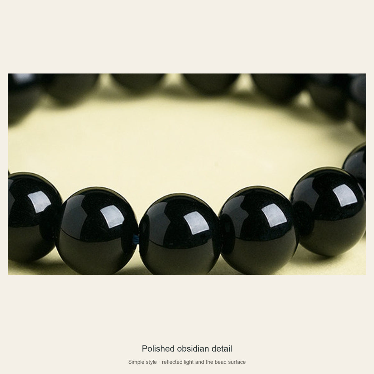Polished black obsidian beads and their reflections close-up