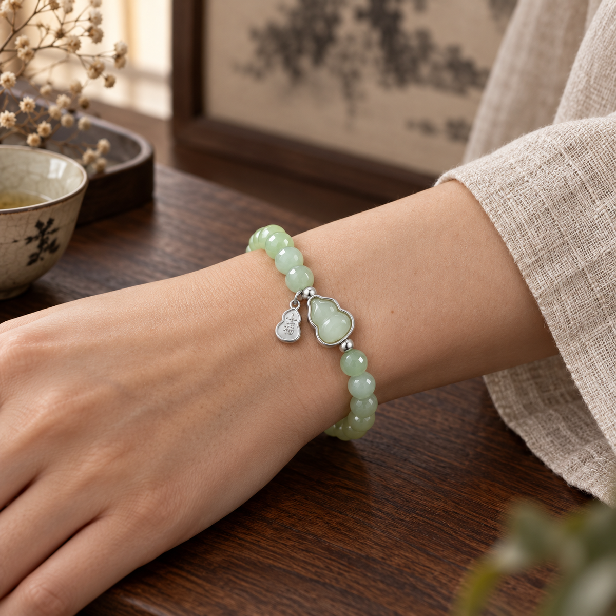AI styling illustration of the Hetian jade and silver gourd bracelet worn on a wrist; not a size reference.