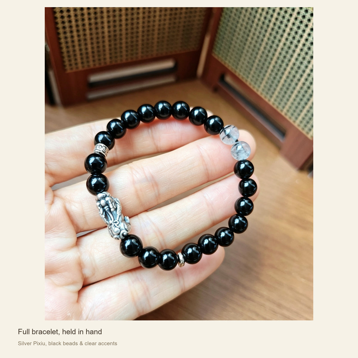 6 mm Obsidian & Fine Silver Pixiu Bracelet — Full bracelet, held in hand; Silver Pixiu, black beads & clear accents