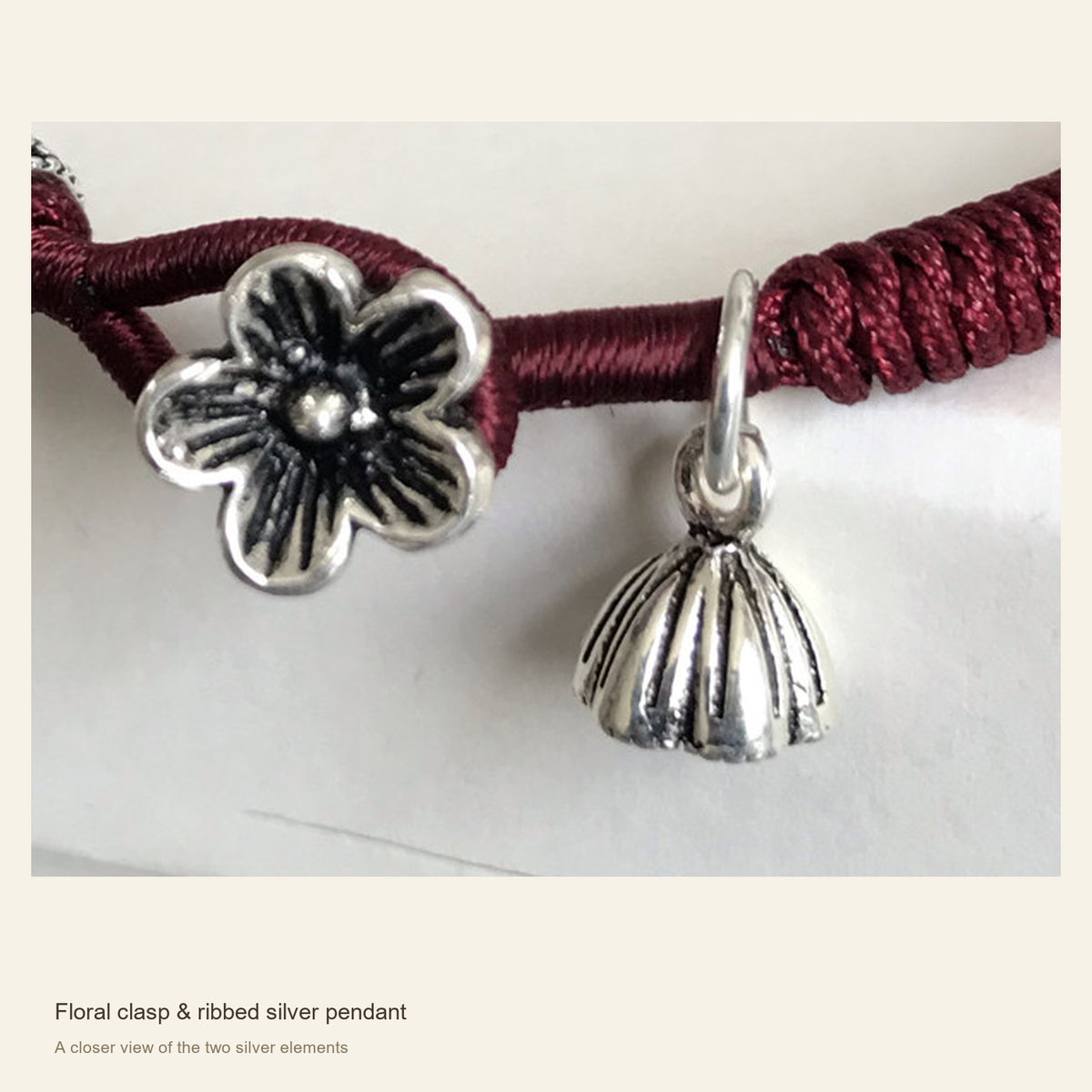 Burgundy Red Cord Bracelet with Sterling Silver Floral Clasp — Floral clasp & ribbed silver pendant; A closer view of the two silver elements