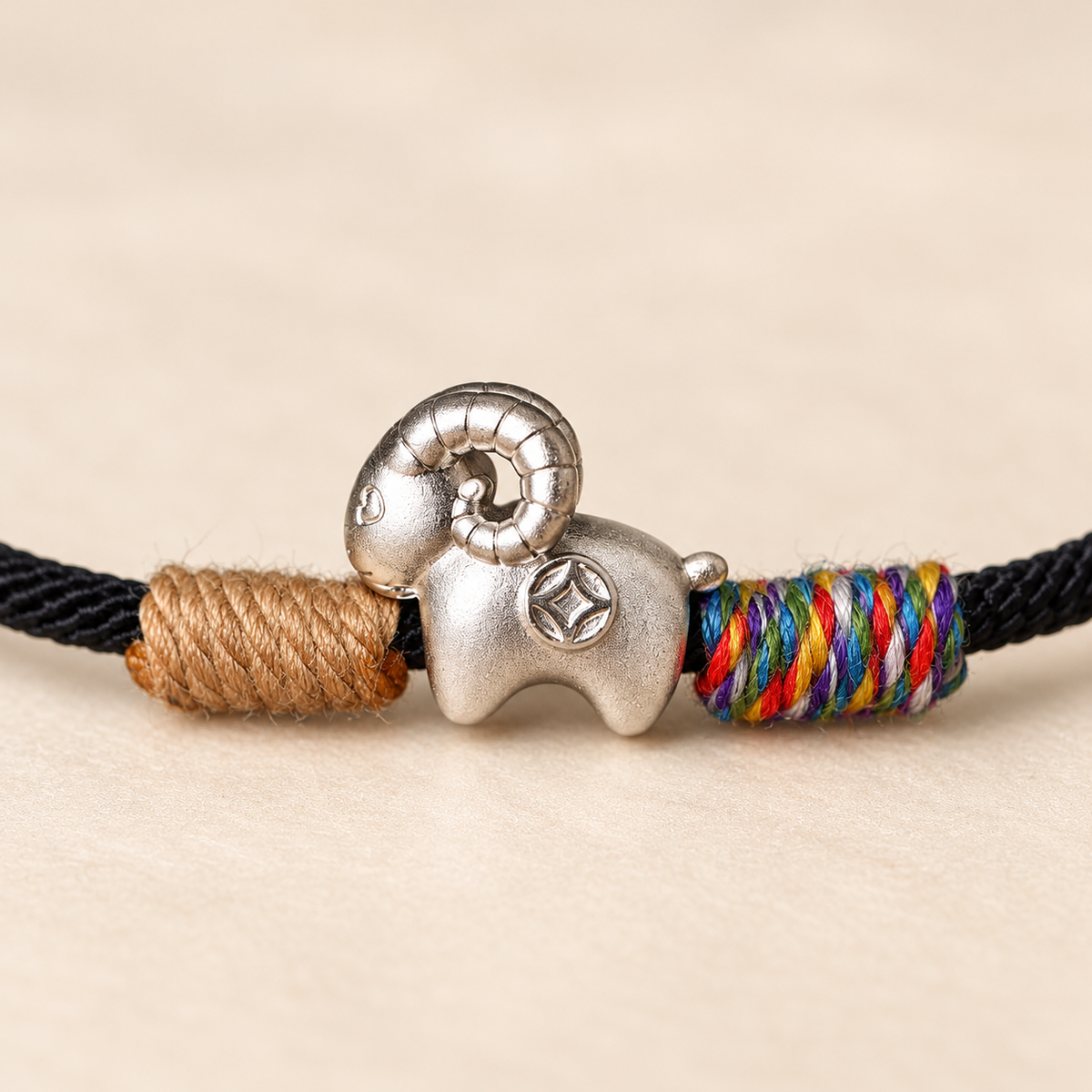 Close view of the fine silver goat and woven black cord #cord color_black